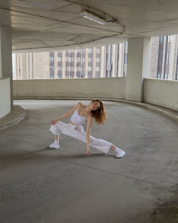 A fit person in a dynamic movement pose, feeling energetic and full of life.