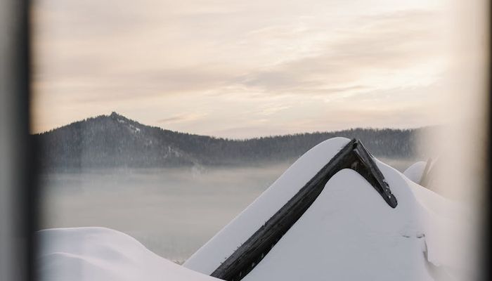 Smiling person stretching outdoors at sunrise, feeling refreshed.